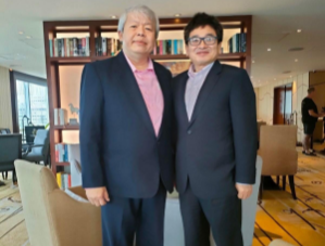 Two business professionals in suits standing together representing the FOXIT Partnership